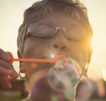 Woman blowing bubbles